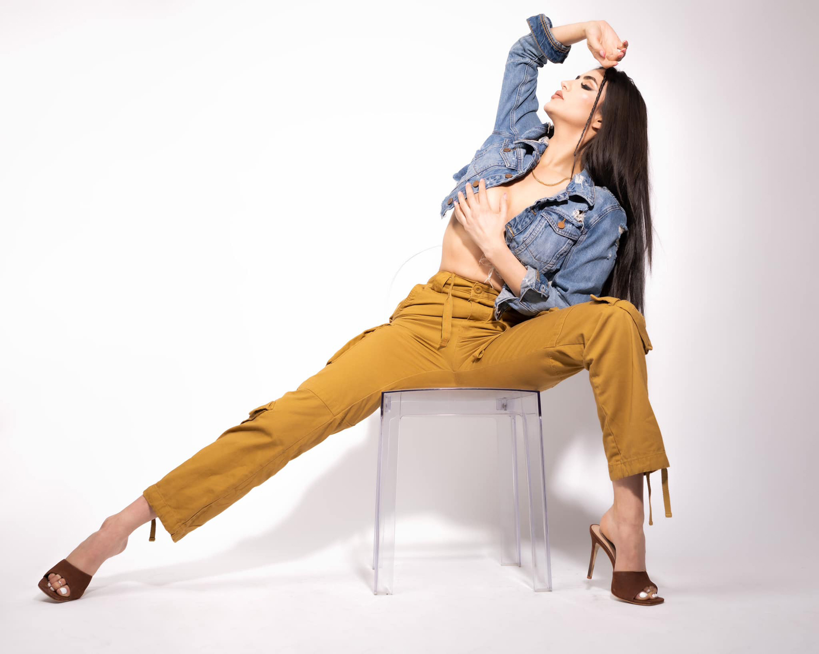 An editorial fashion portrait on a white backdrop with sculpted, graphic makeup
